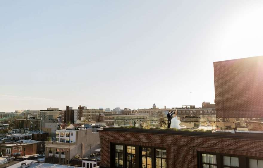 Bride and Groom dancing on rooftop during sunset at wedding reception at The Line Hotel Washington DC