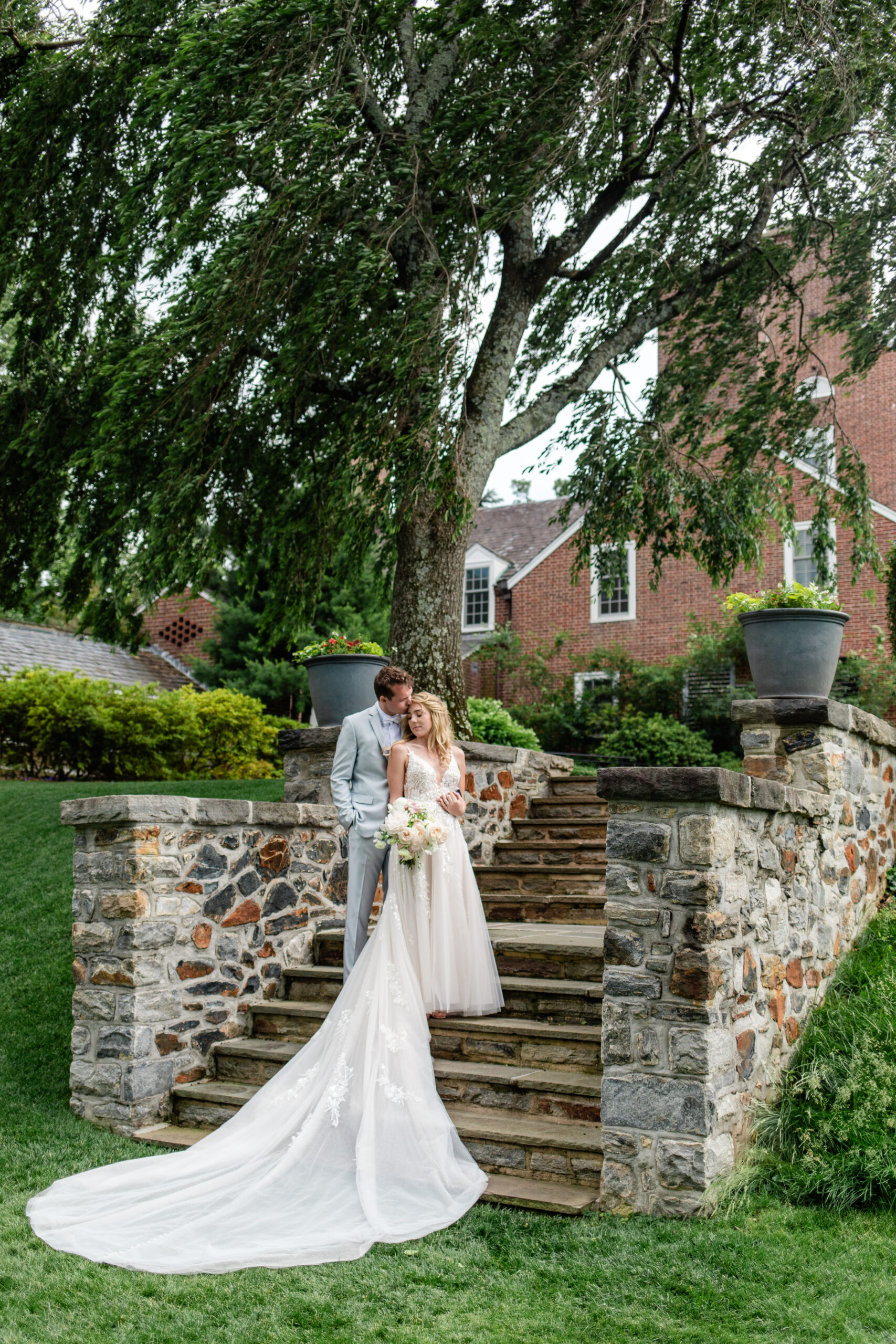 couple embraces on steps of Baltimore Country Club