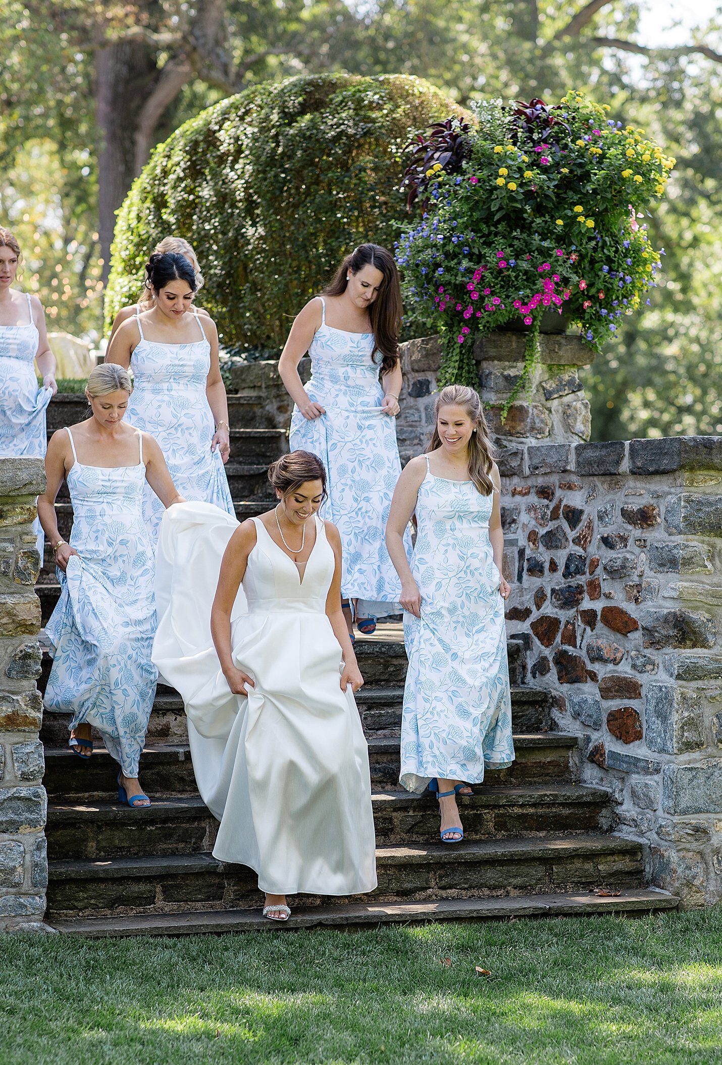 spring bride walks down steps at Baltimore Country Club