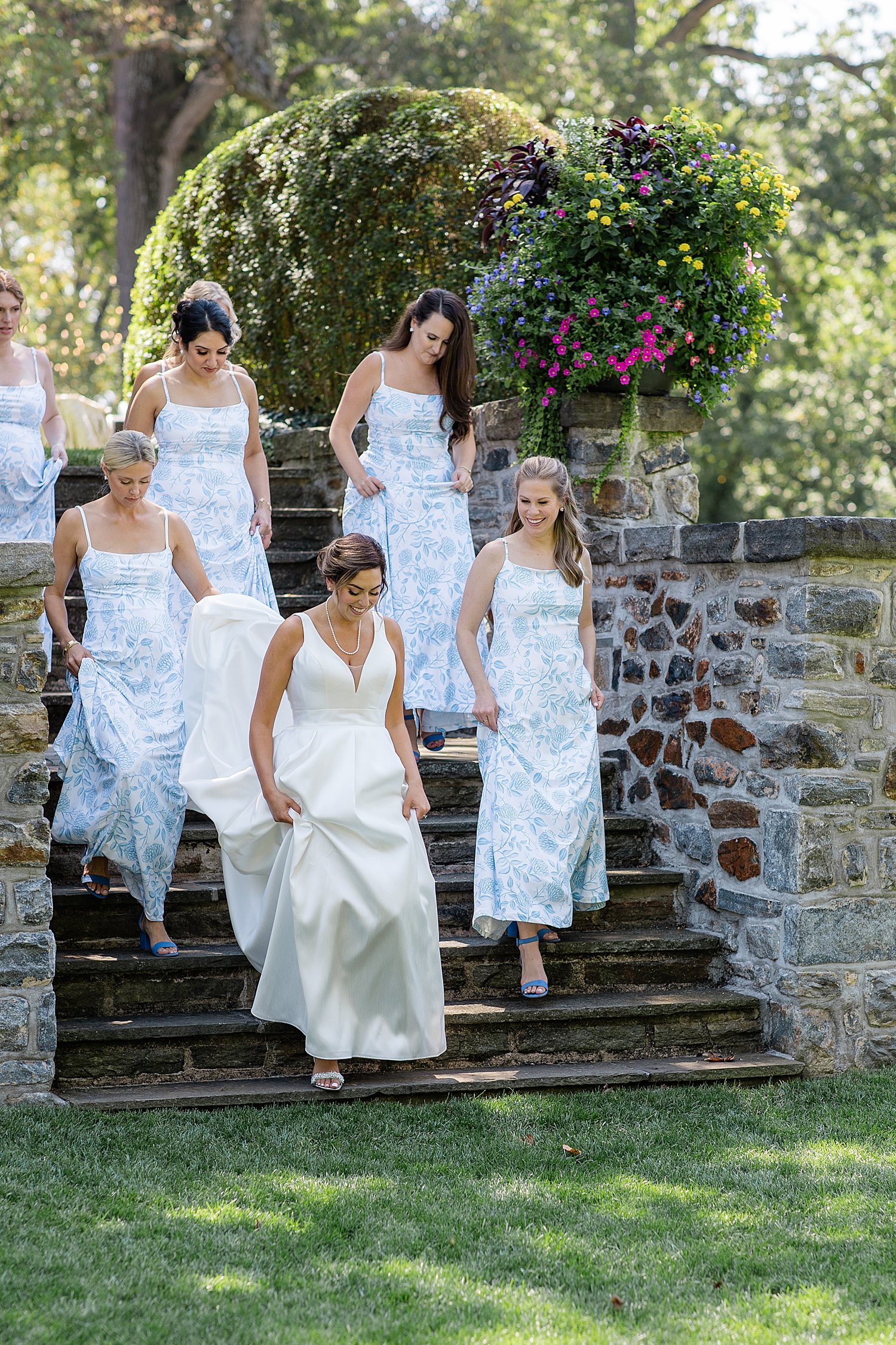 spring bride walks down steps at Baltimore Country Club