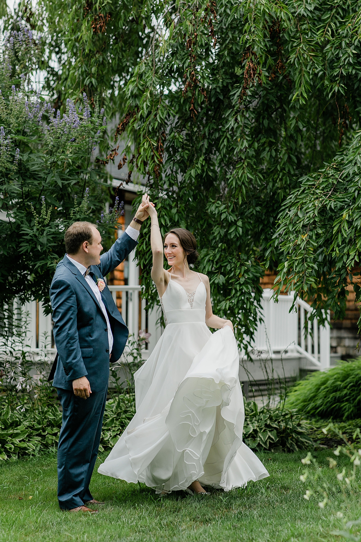 man twirls his new wife outside the house of London Town & Gardens