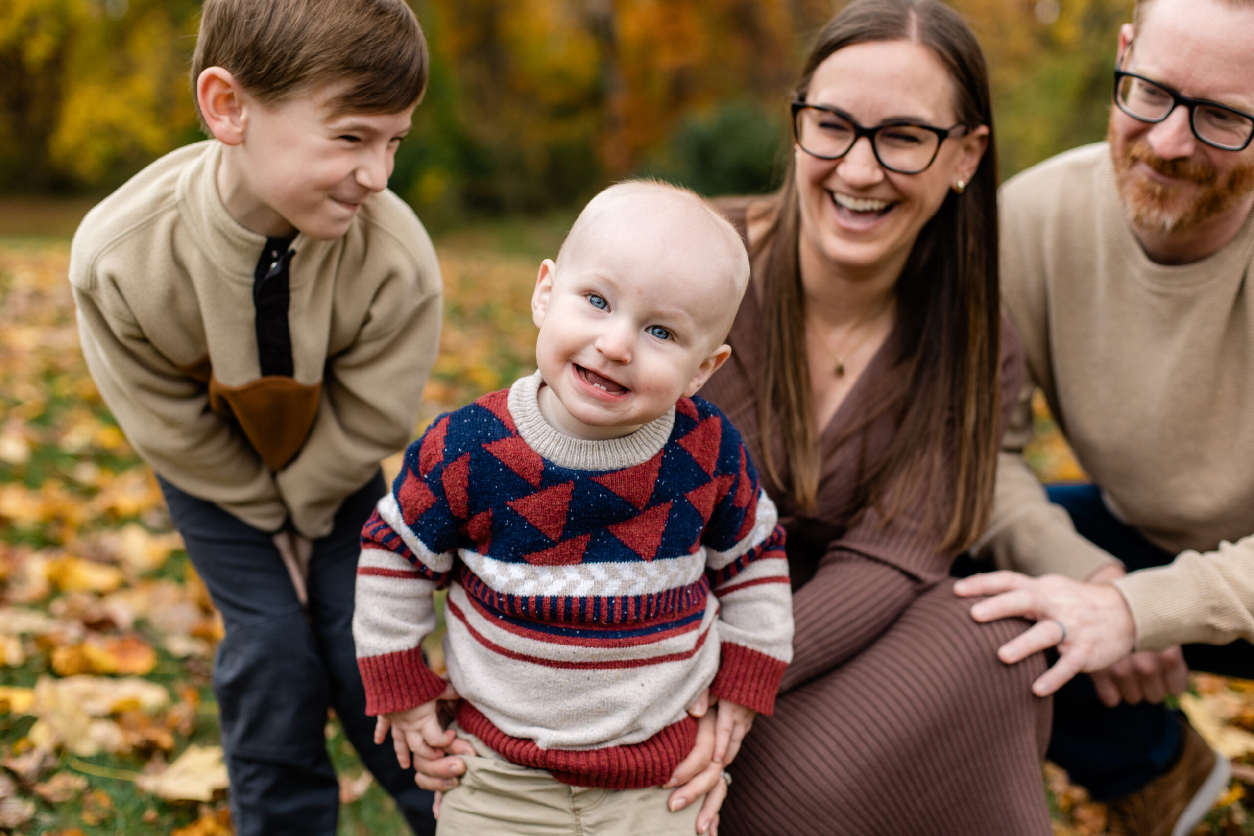 siblings portrait with coordinated fall outfits standing on a wooden dock in Baltimore harbor