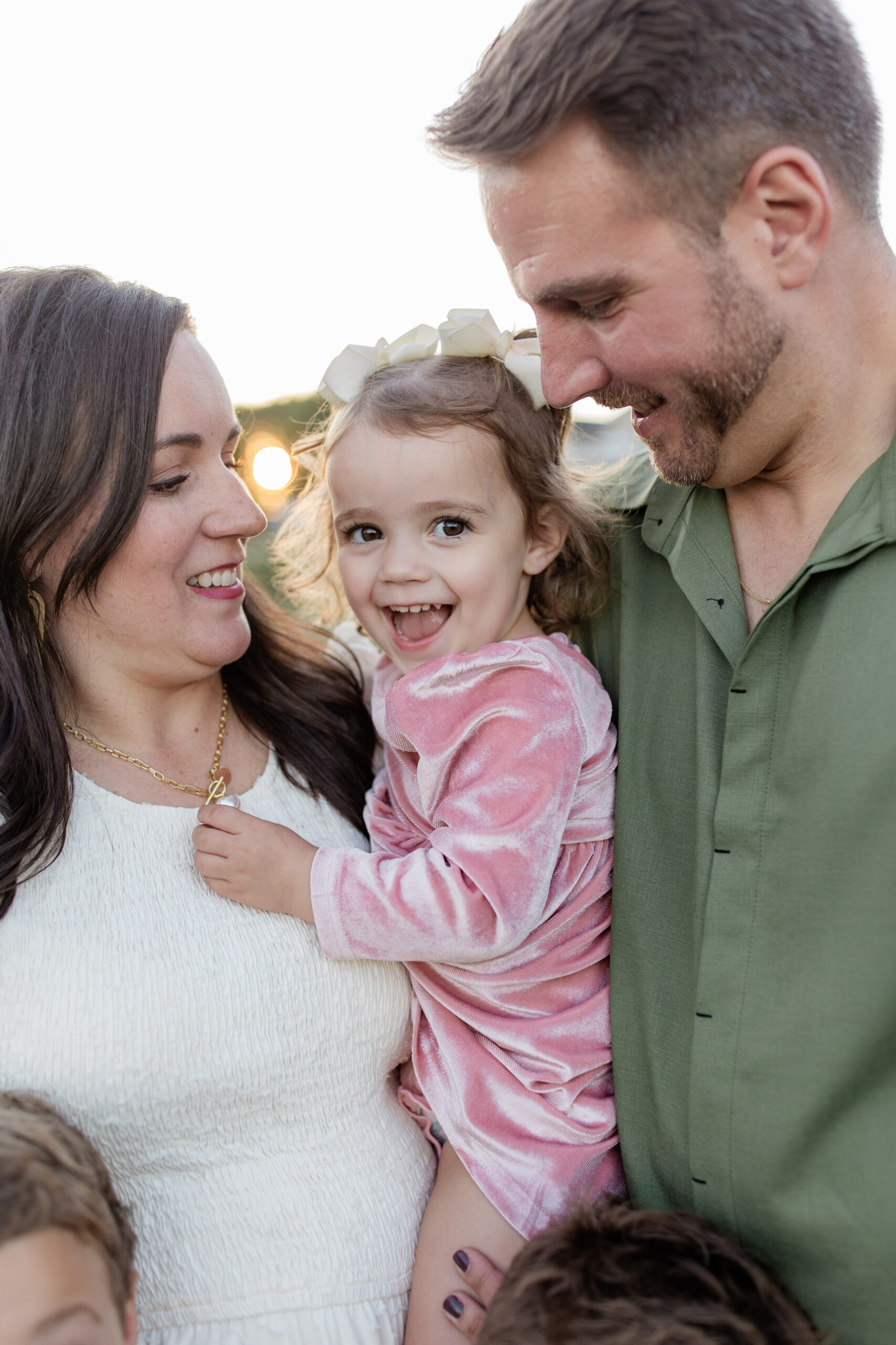 family photoshoot with soft pastels and coordinated colors during a vineyard family session