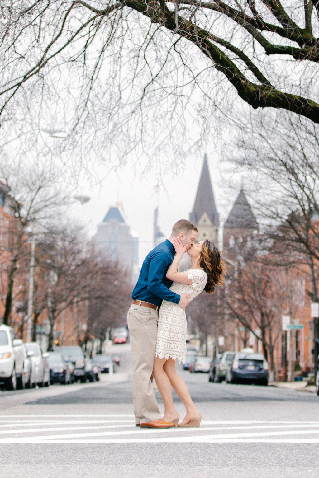 a newly married couples kissing at the entrance of the patterson park in baltimore