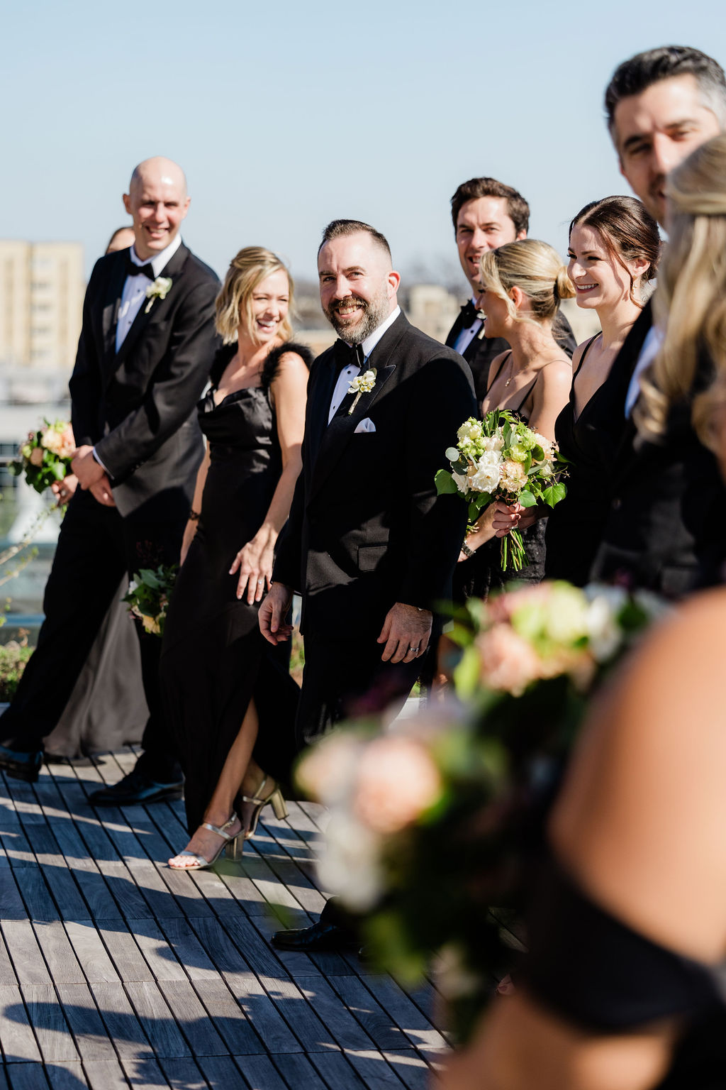 wedding party portraits on rooftop overlooking washington dc skyline 