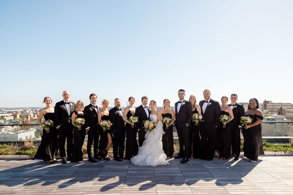 full wedding party portrait with washington dc skyline backdrop 
