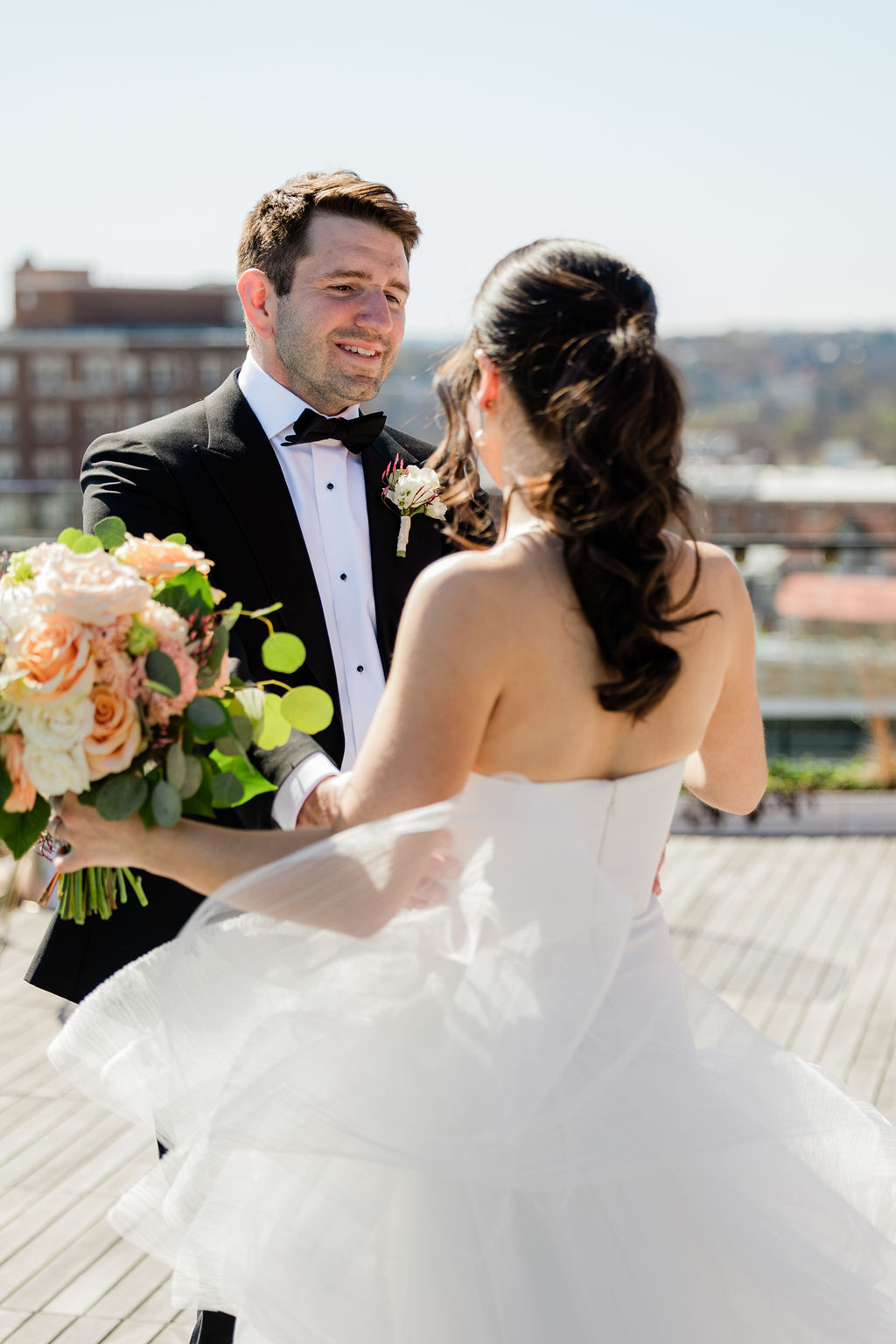 bride and groom sharing a moment on rooftop terrace with washington dc skyline views