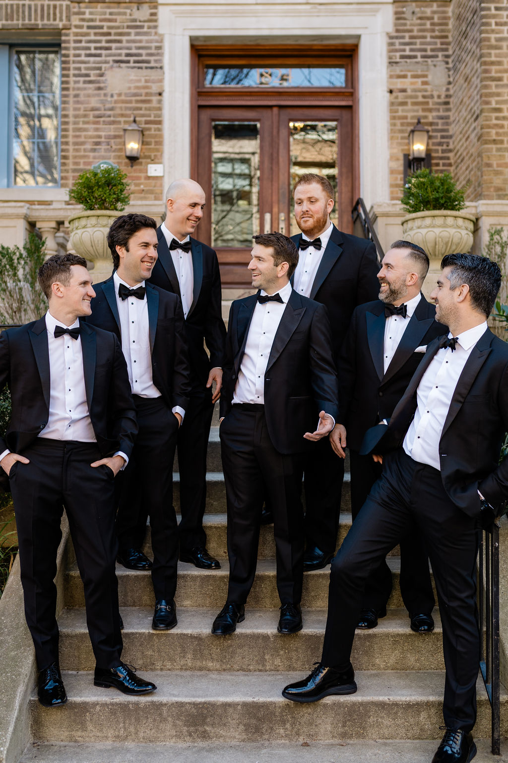 groom and groomsmen portraits in classic black tuxedos before washington dc wedding ceremony