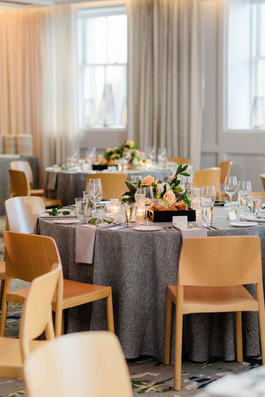 elegant reception tablescape with candles and soft neutral linens creating a timeless wedding atmosphere