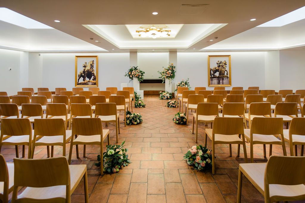 floral ceremony altar design at The Line DC wedding venue with romantic peach and greenery flowers