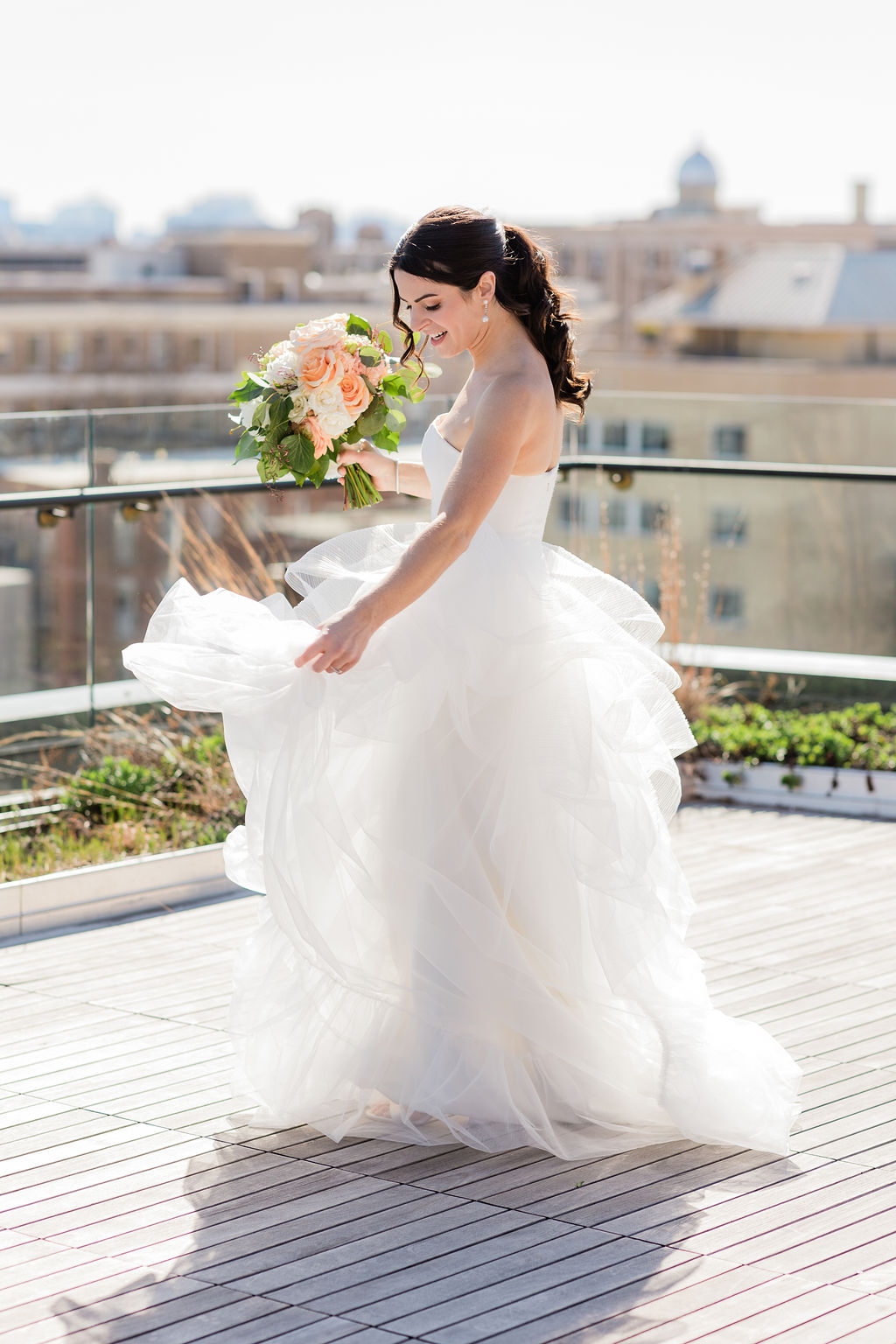 A bride twirling her bridal gown under the sun light 