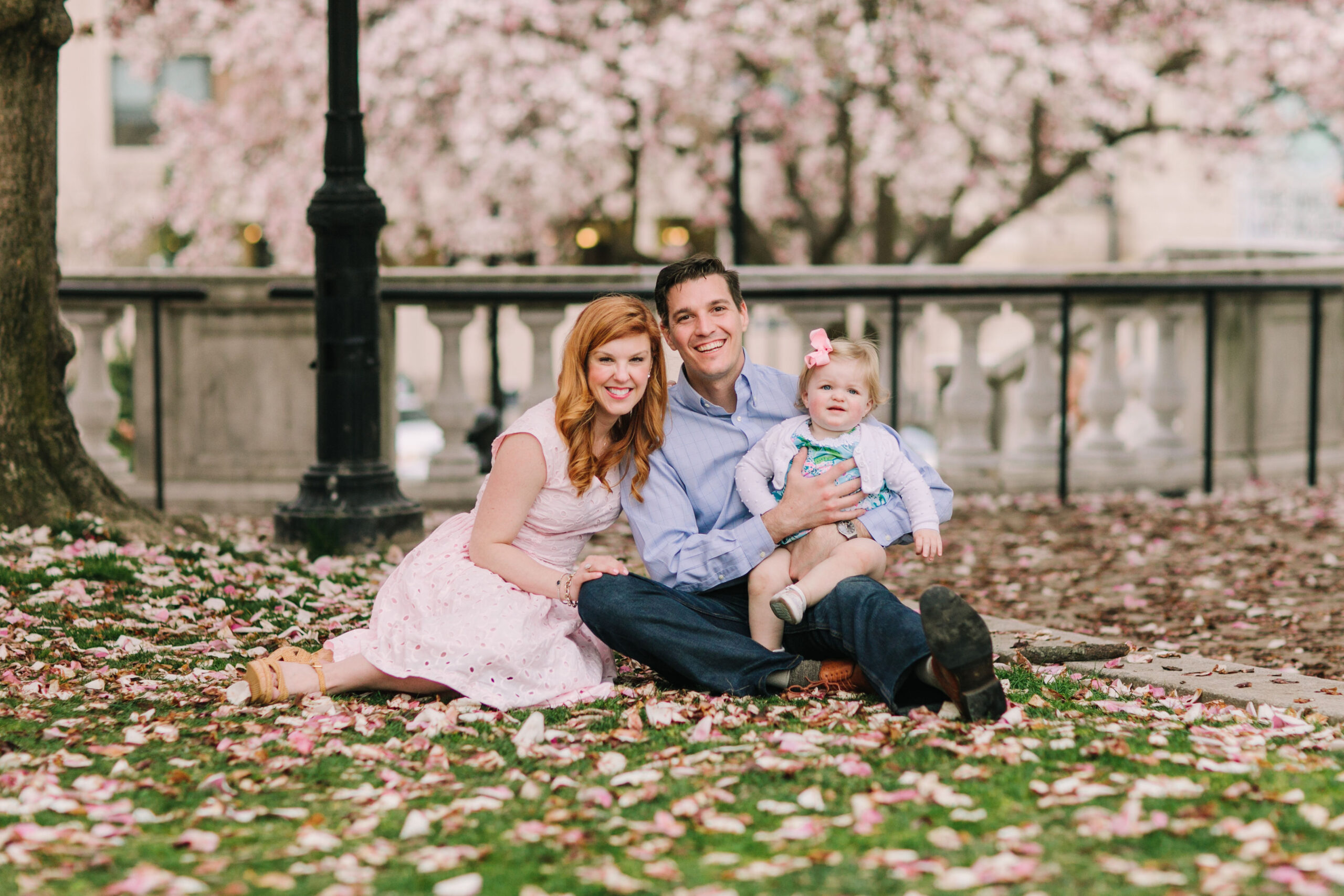 Spring photoshoot locations Baltimore family under blooming cherry blossom tree