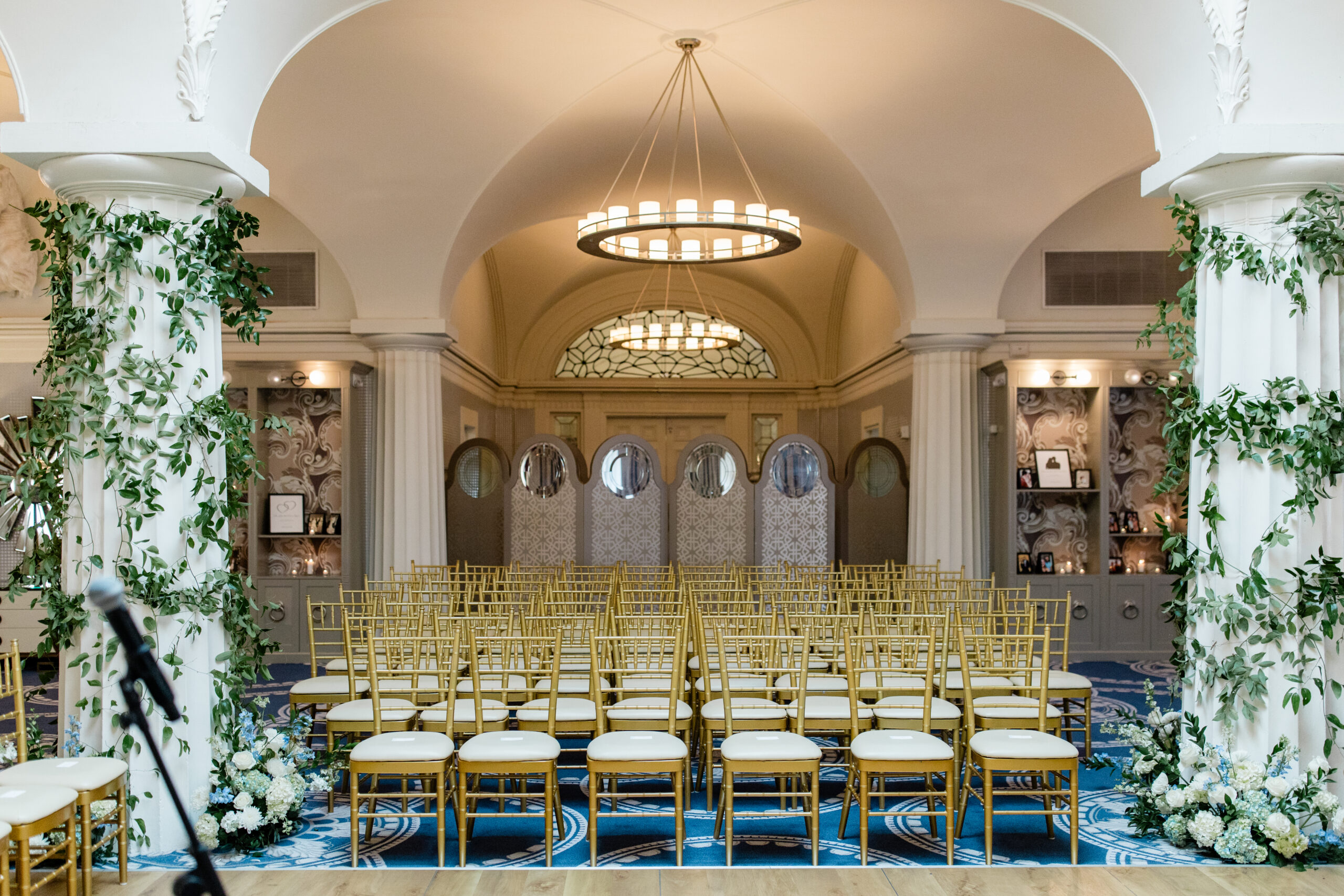 hotel monaco washington ceremony space symmetrical setup with floral arrangements