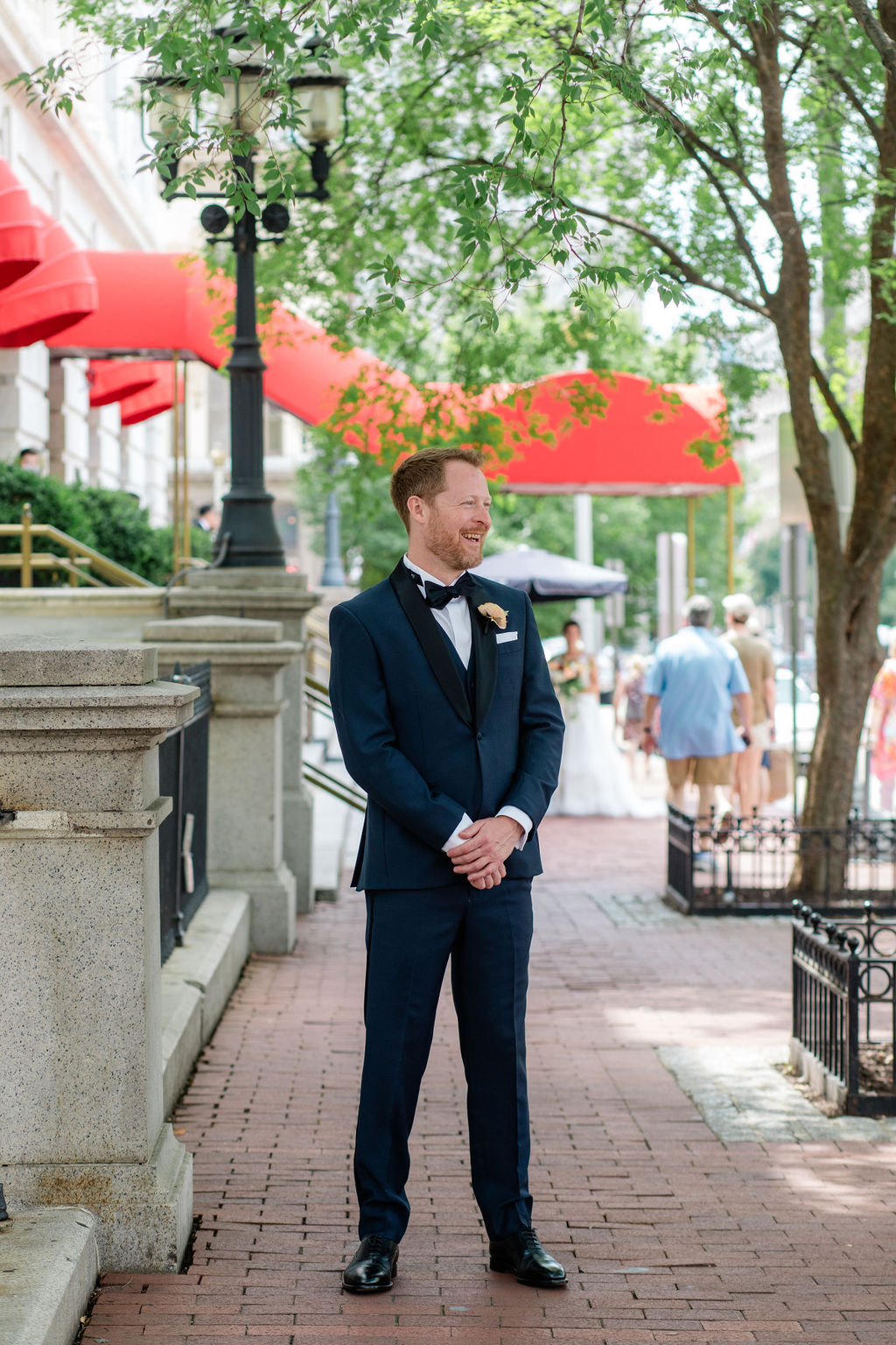 groom portrait on washington dc street with classic architecture and red awnings