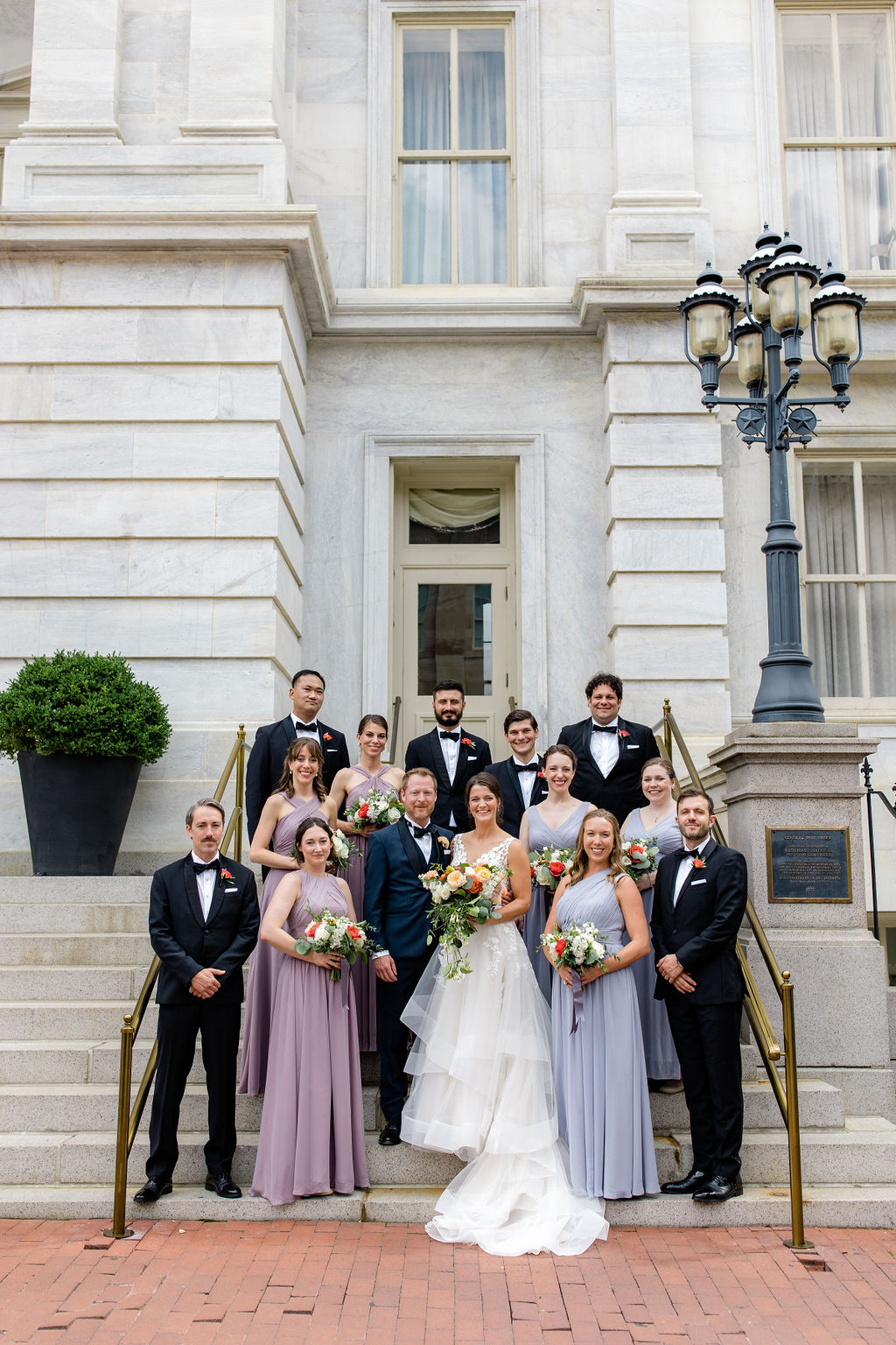 washington dc wedding party portraits on stone steps with elegant architecture backdrop