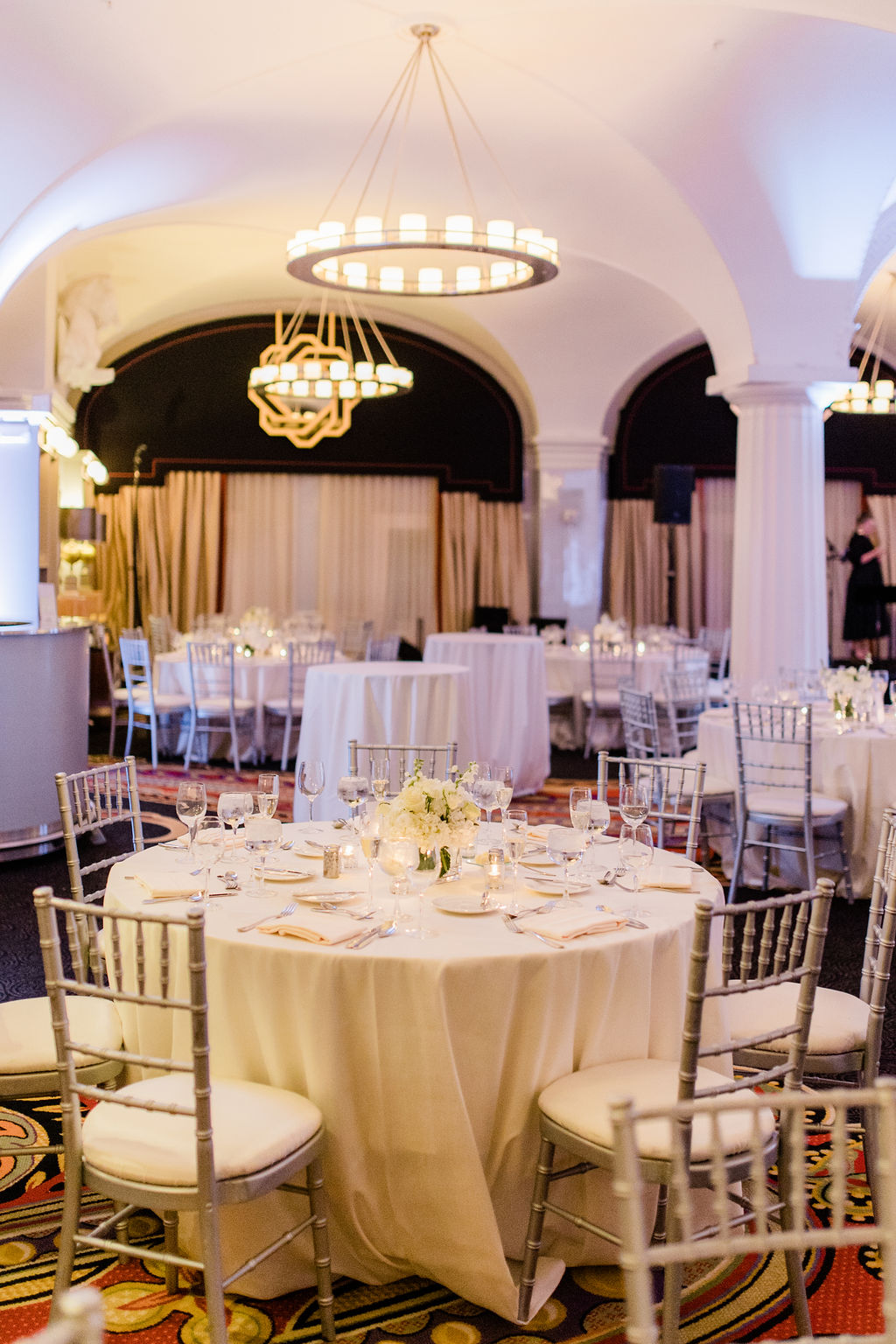 softly lit wedding reception space with round tables and candlelight ambiance