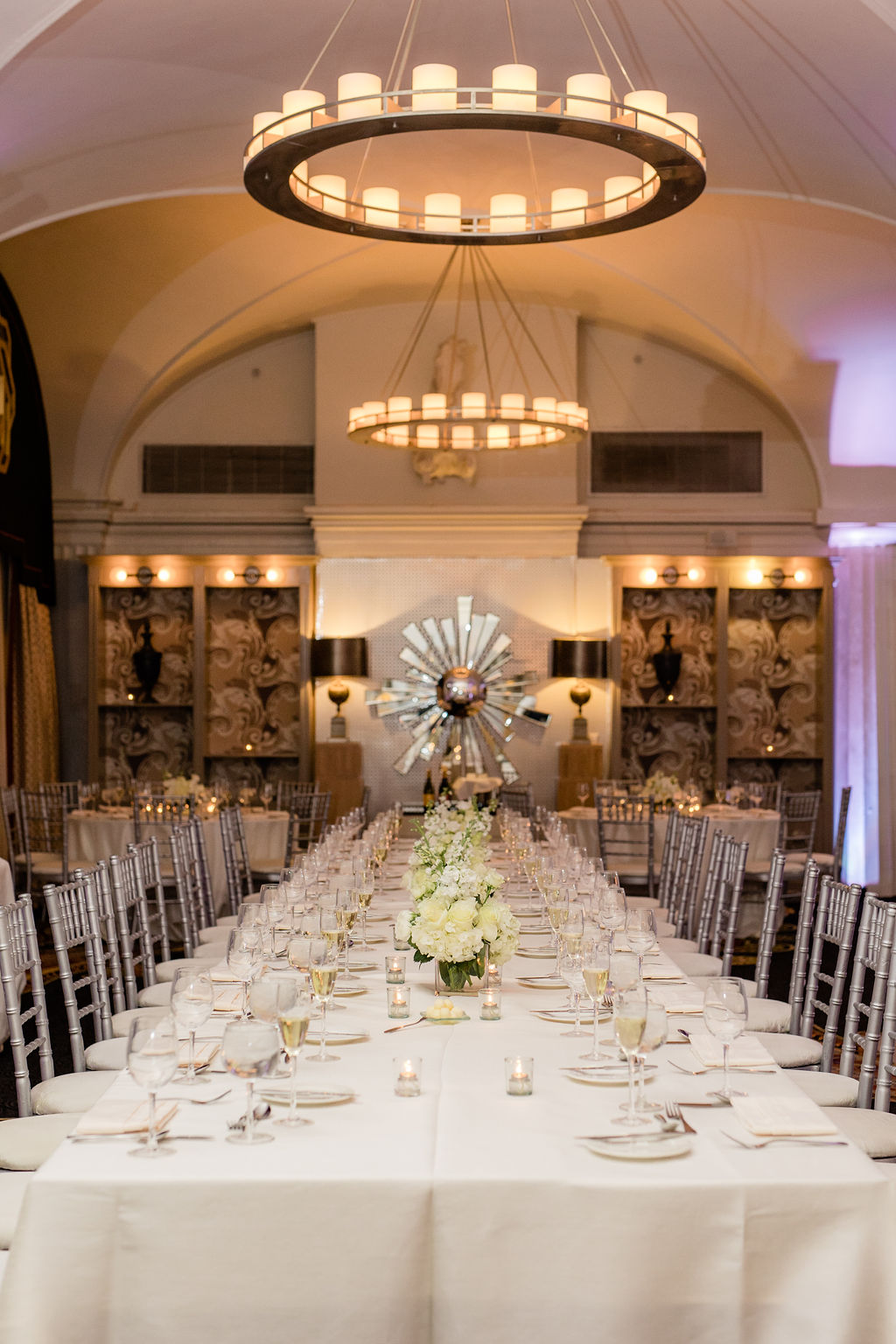 elegant wedding reception table with white linens, candles, and floral centerpiece at the hotel monaco washington