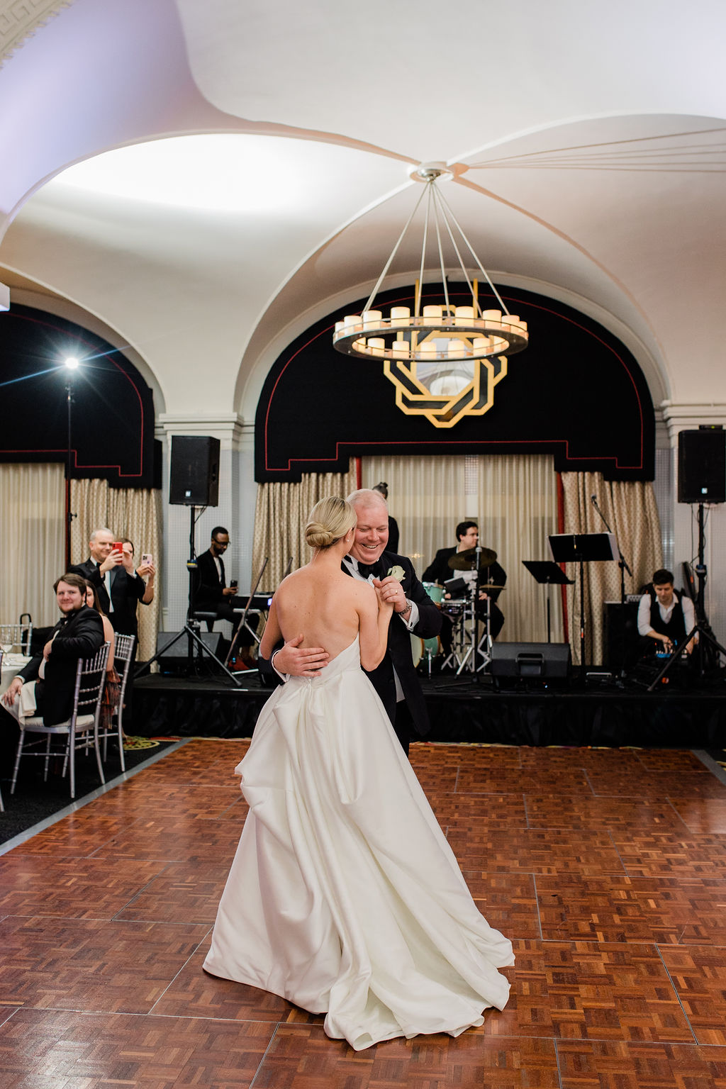 bride and groom sharing their first dance on a wooden dance floor with live band at the hotel monaco washington