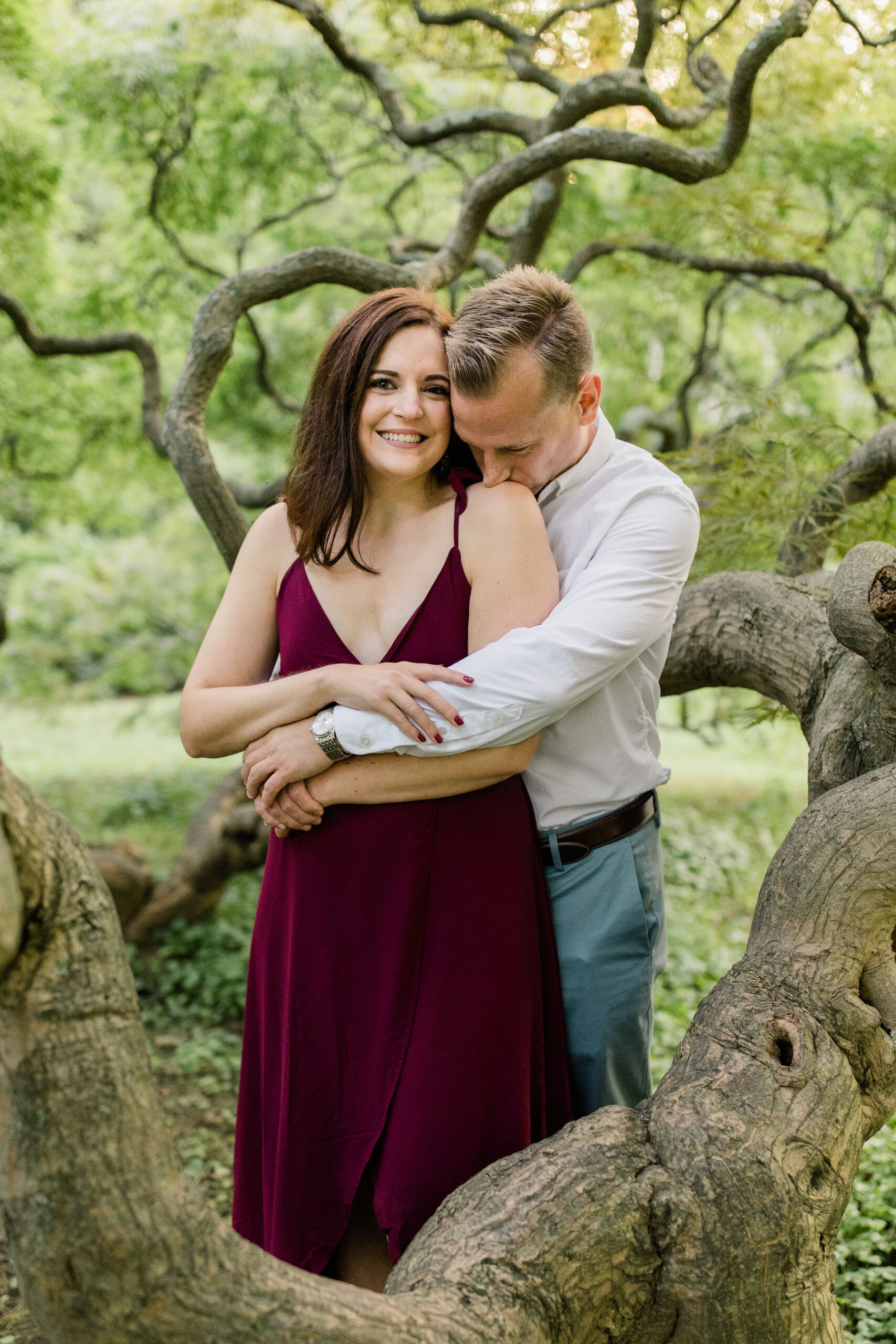 Romantic couple portrait beneath twisting tree branches at Cylburn Arboretum engagement session in Baltimore