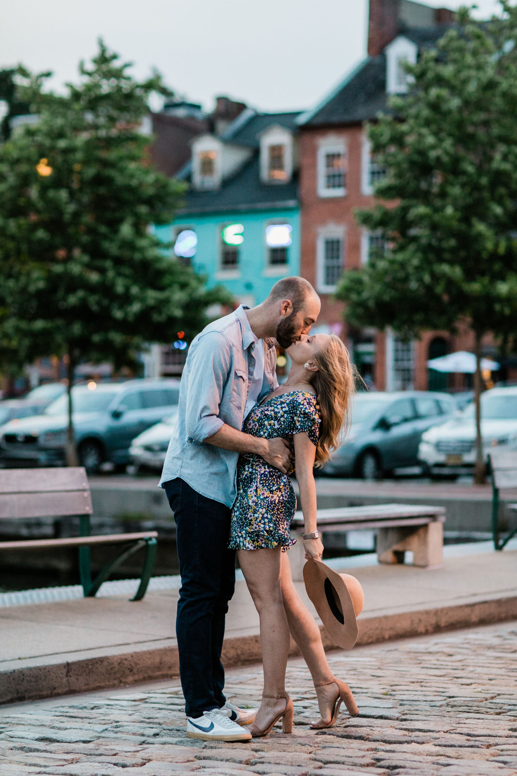 Romantic cobblestone street kiss in Fells Point during a Baltimore waterfront engagement session