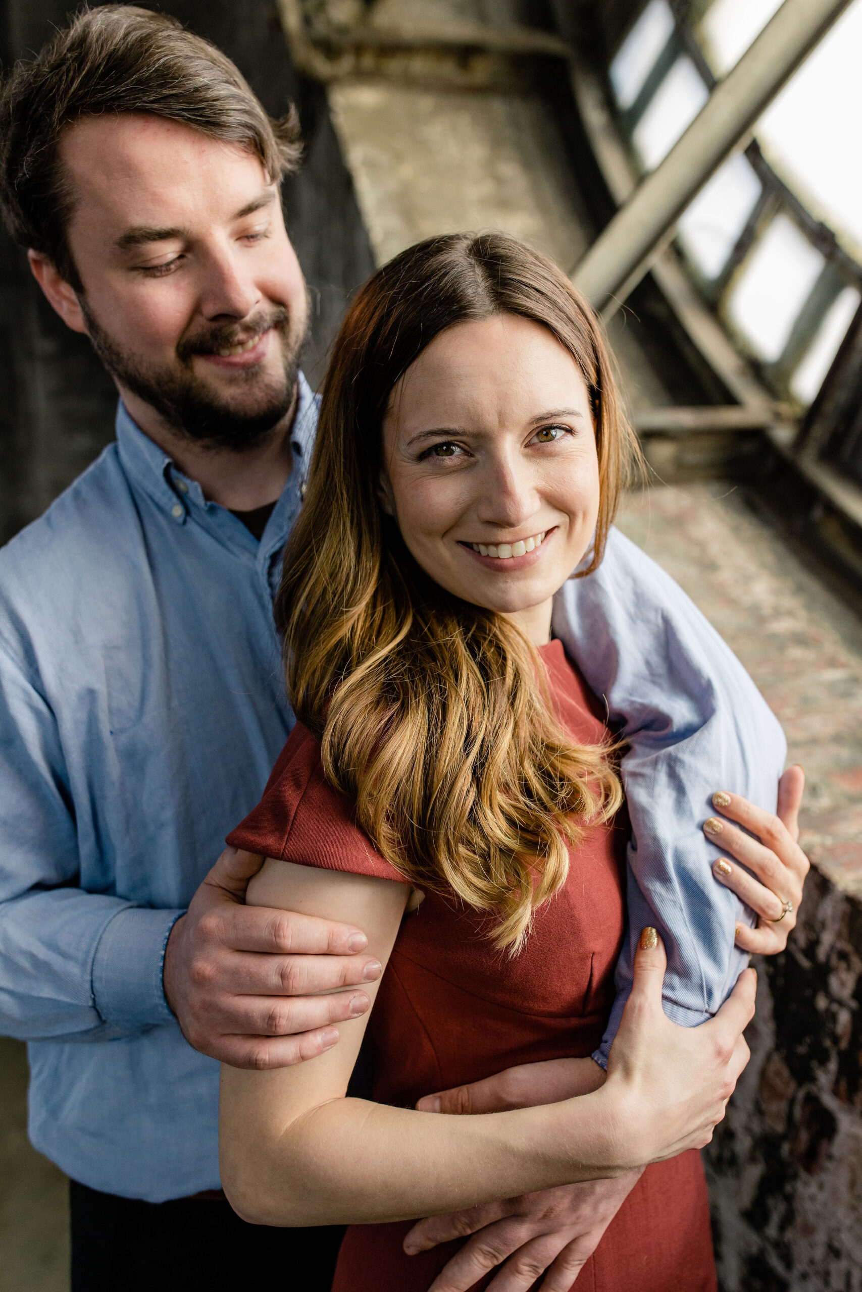 Couple embracing inside the Bromo Seltzer Tower during a Baltimore engagement session at one of the most unique engagement photo locations in Baltimore