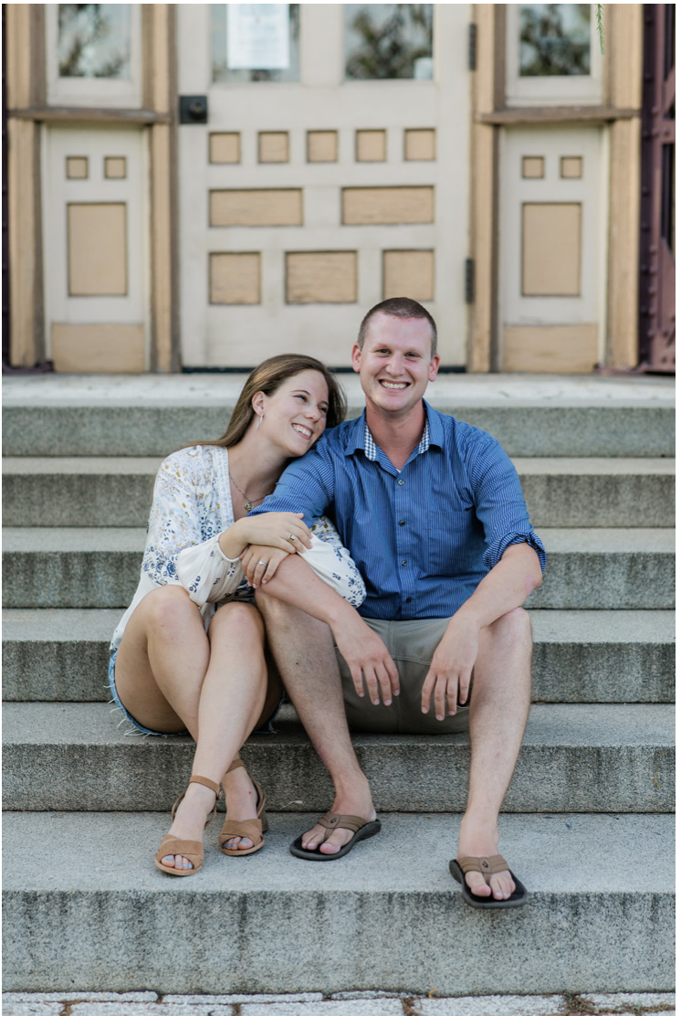 Casual engagement photo pose on historic Baltimore steps with relaxed summer engagement outfit inspiration