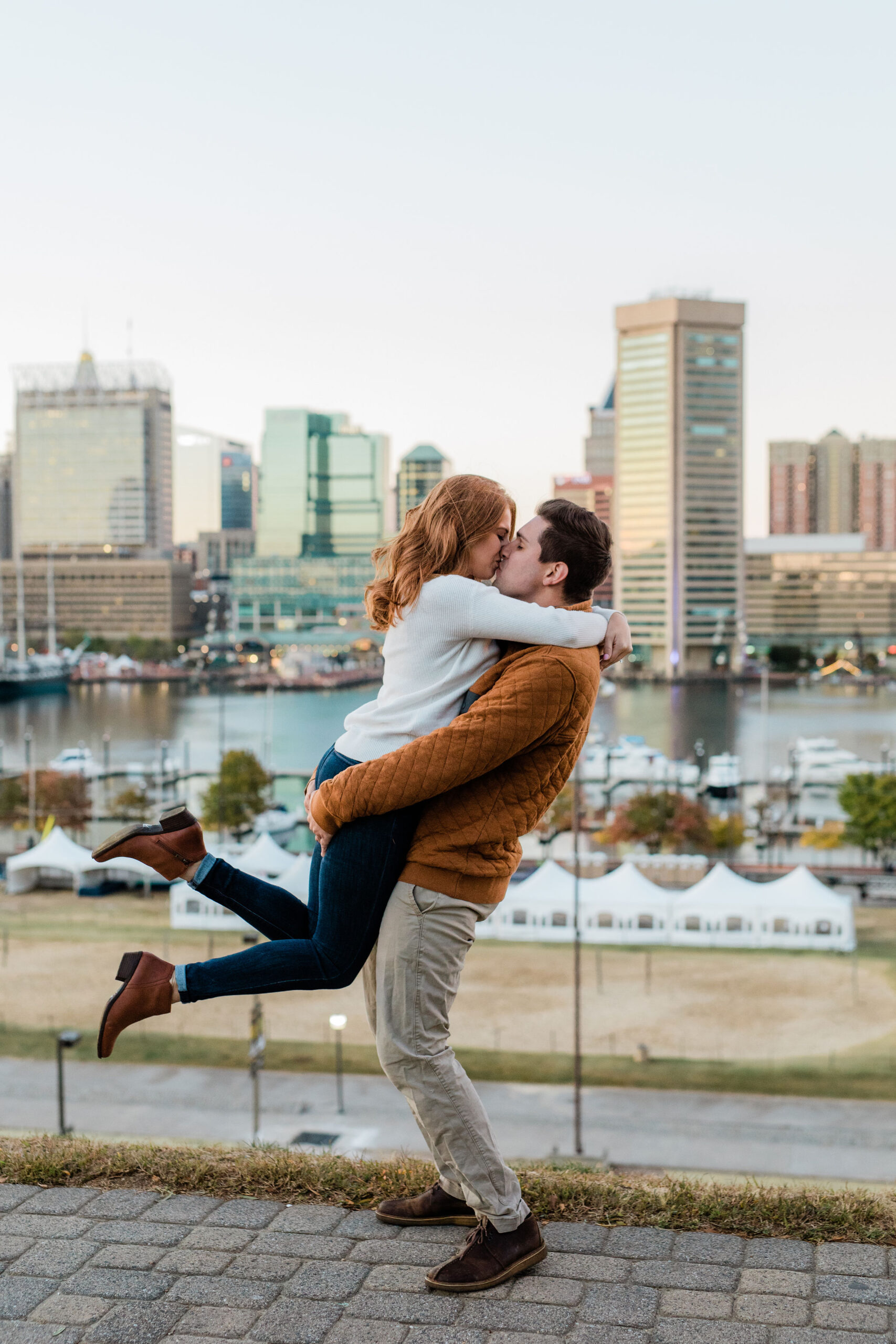 Federal Hill Baltimore engagement session with skyline views and playful engagement photo pose inspiration