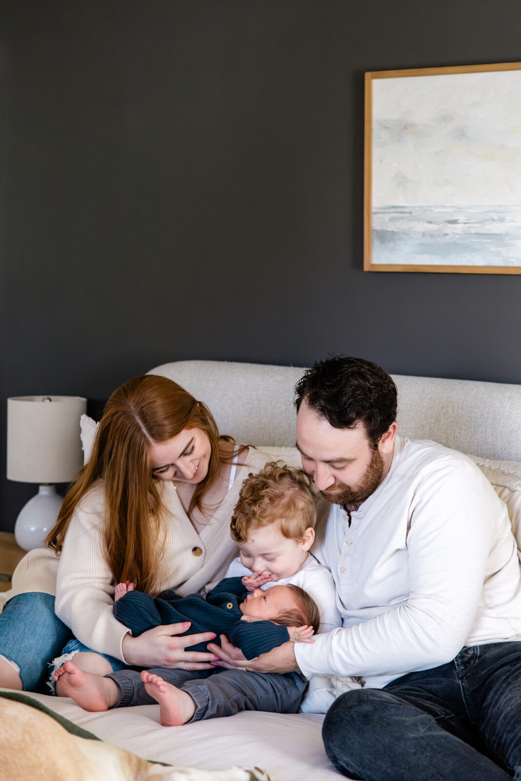 A family of four captured by a Baltimore family photographer in their home.