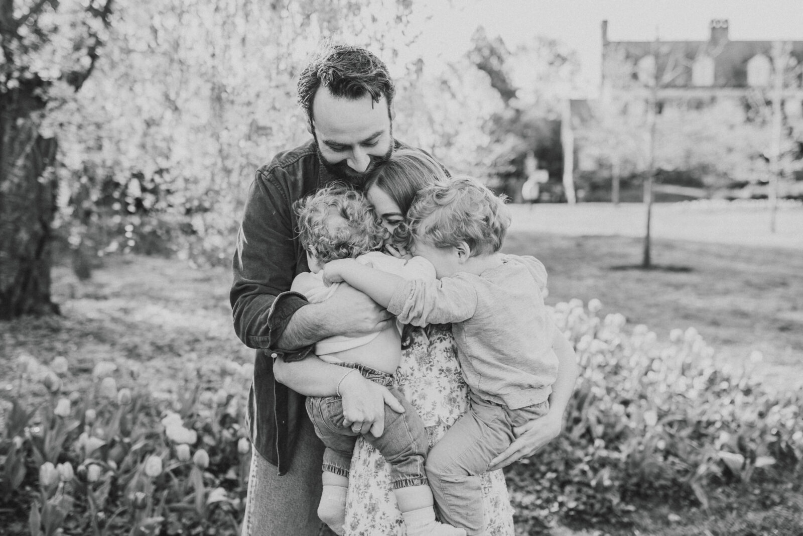 A family photo in a park with a garden captured by a Baltimore family photographer.
