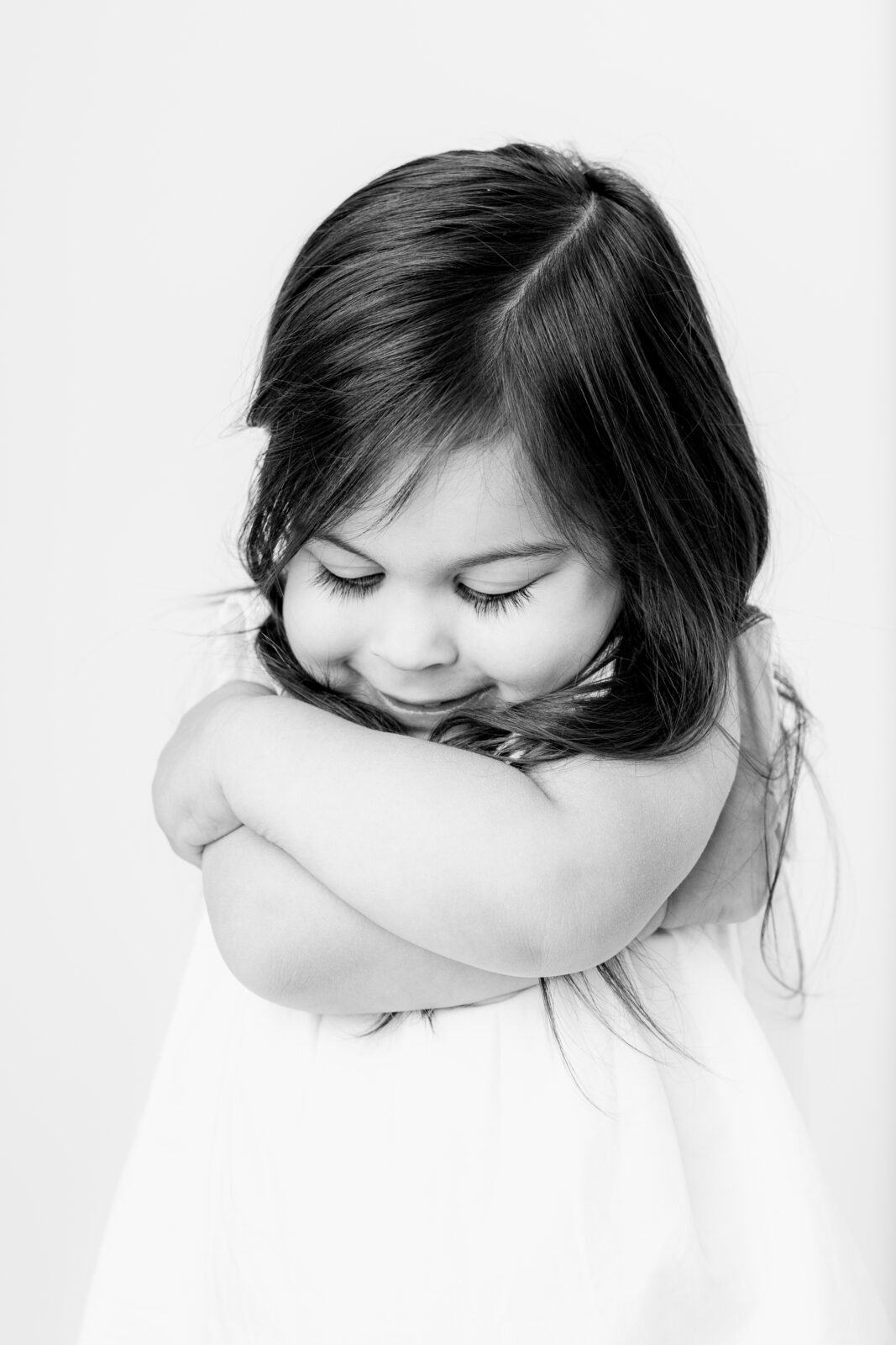 Baltimore children's portrait photographer captures child hugging herself during a personality portrait session