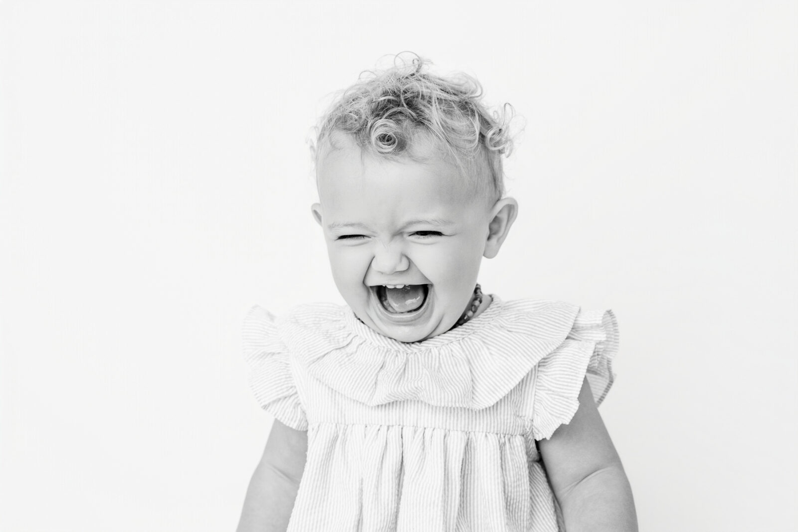 Toddler-age child laughing
