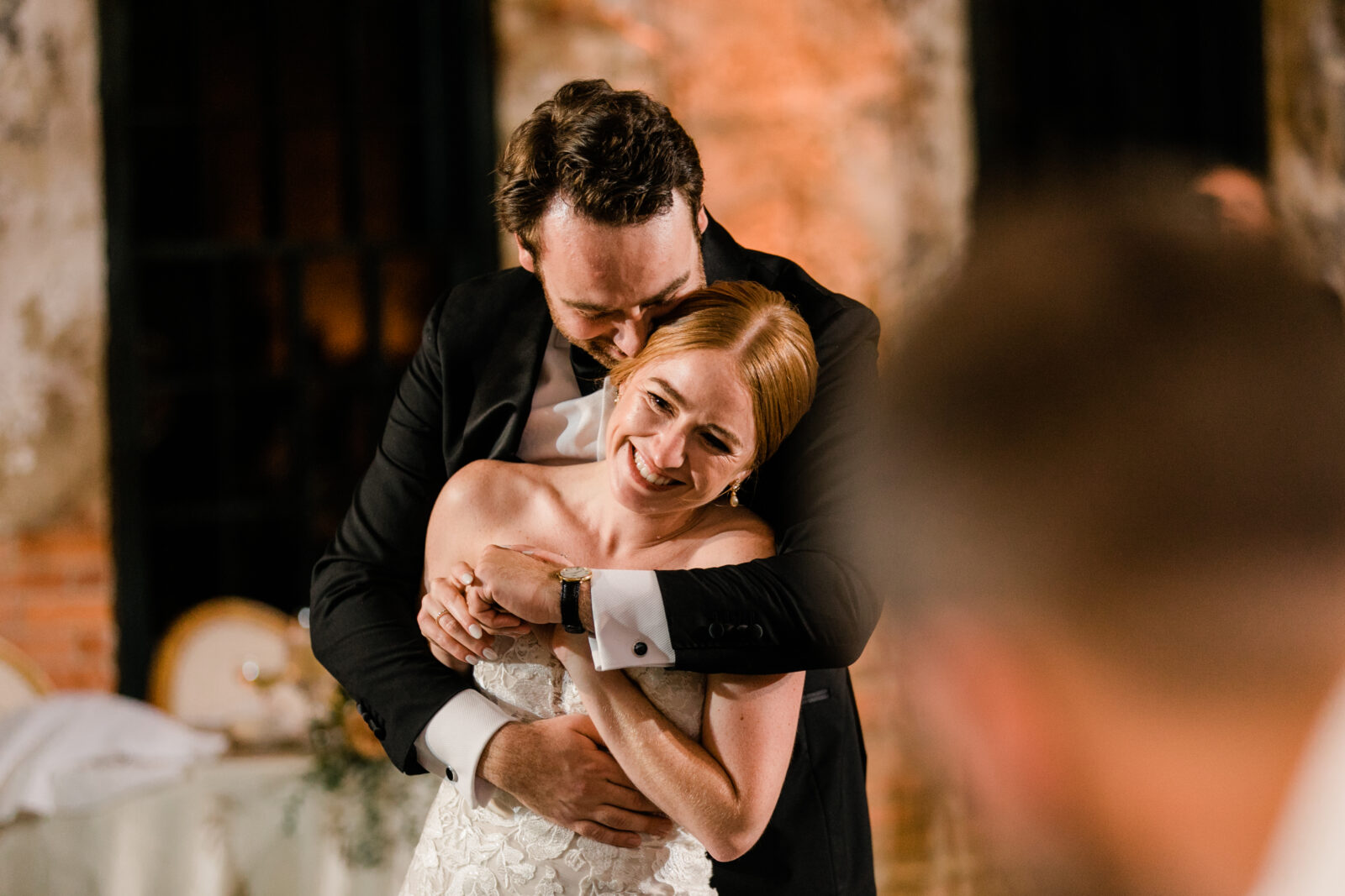 A bride and groom dancing at their wedding reception.