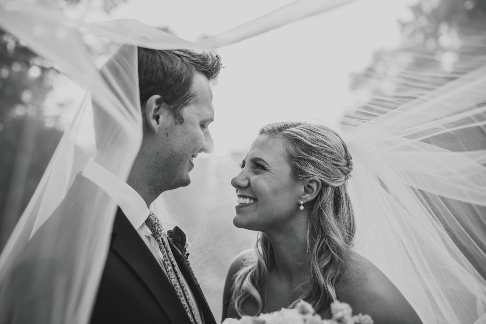 black and white timeless wedding photography of smiling couple