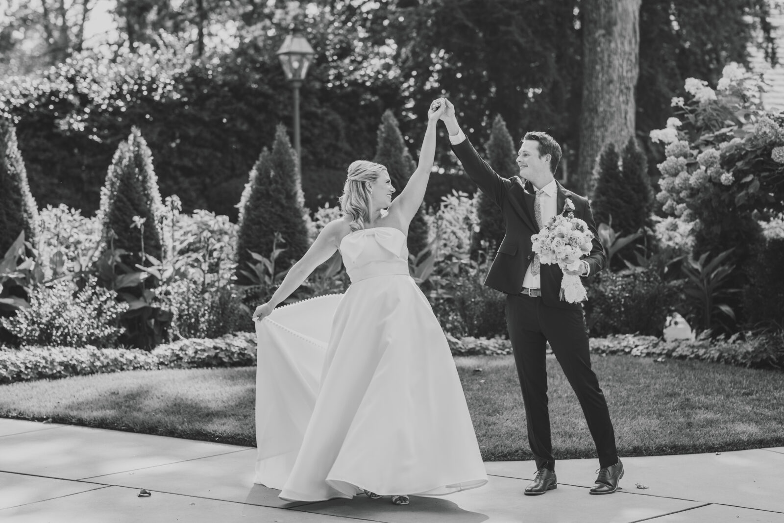 black and white timeless wedding photography couple sharing quiet moment before ceremony in a garden setting