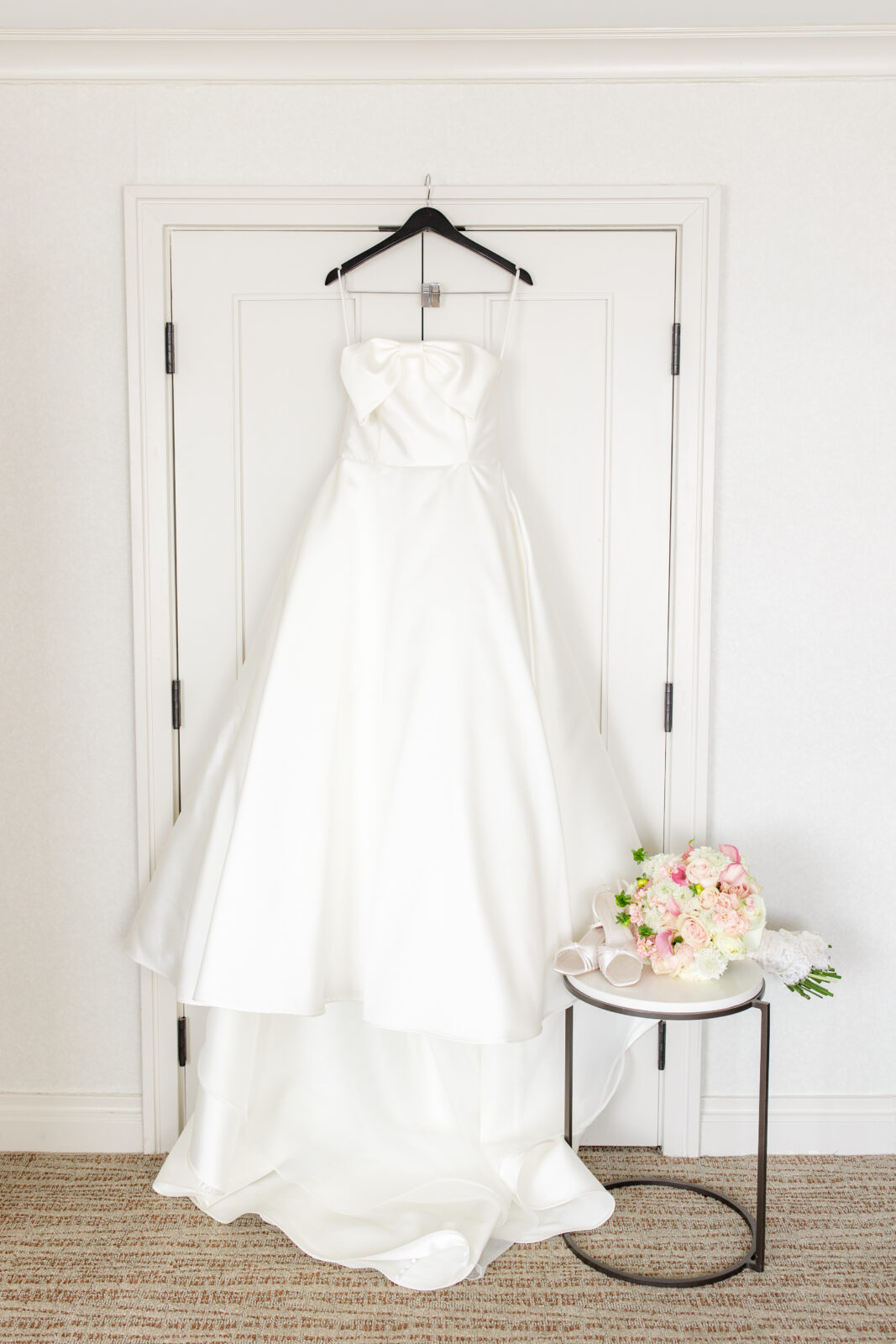 timeless wedding dress hanging in bridal suite