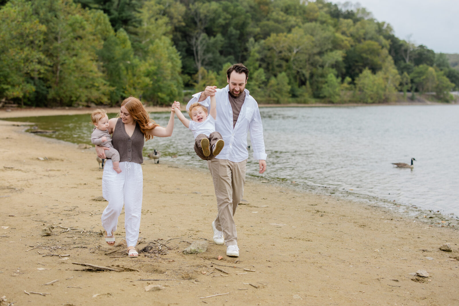 A family of four walking on the beach captured by a Baltimore family photographer.