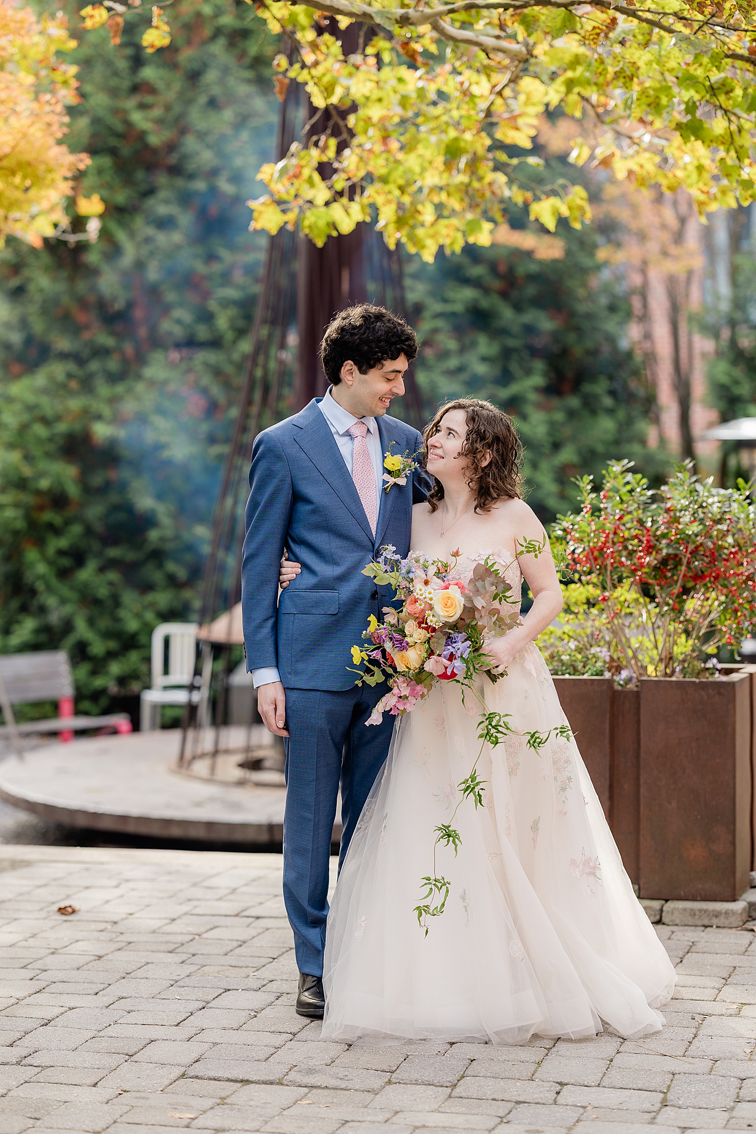bride and groom stand in courtyard at Woodberry Kitchen