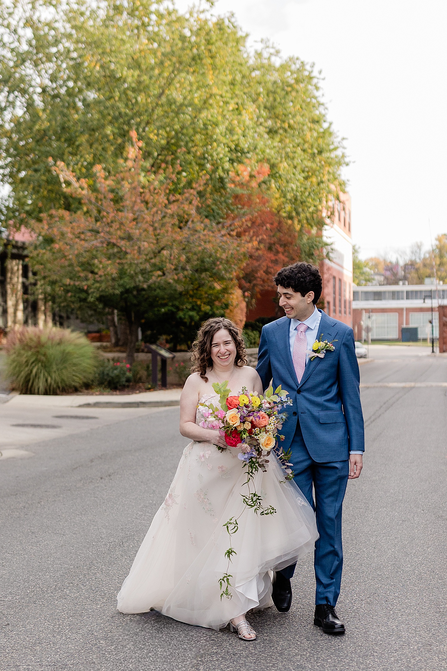 newlyweds walk on street at Woodberry Kitchen