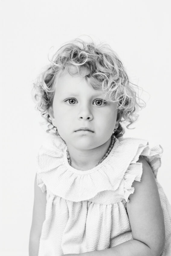 black and white photo of a young girl with a serious facial expression
