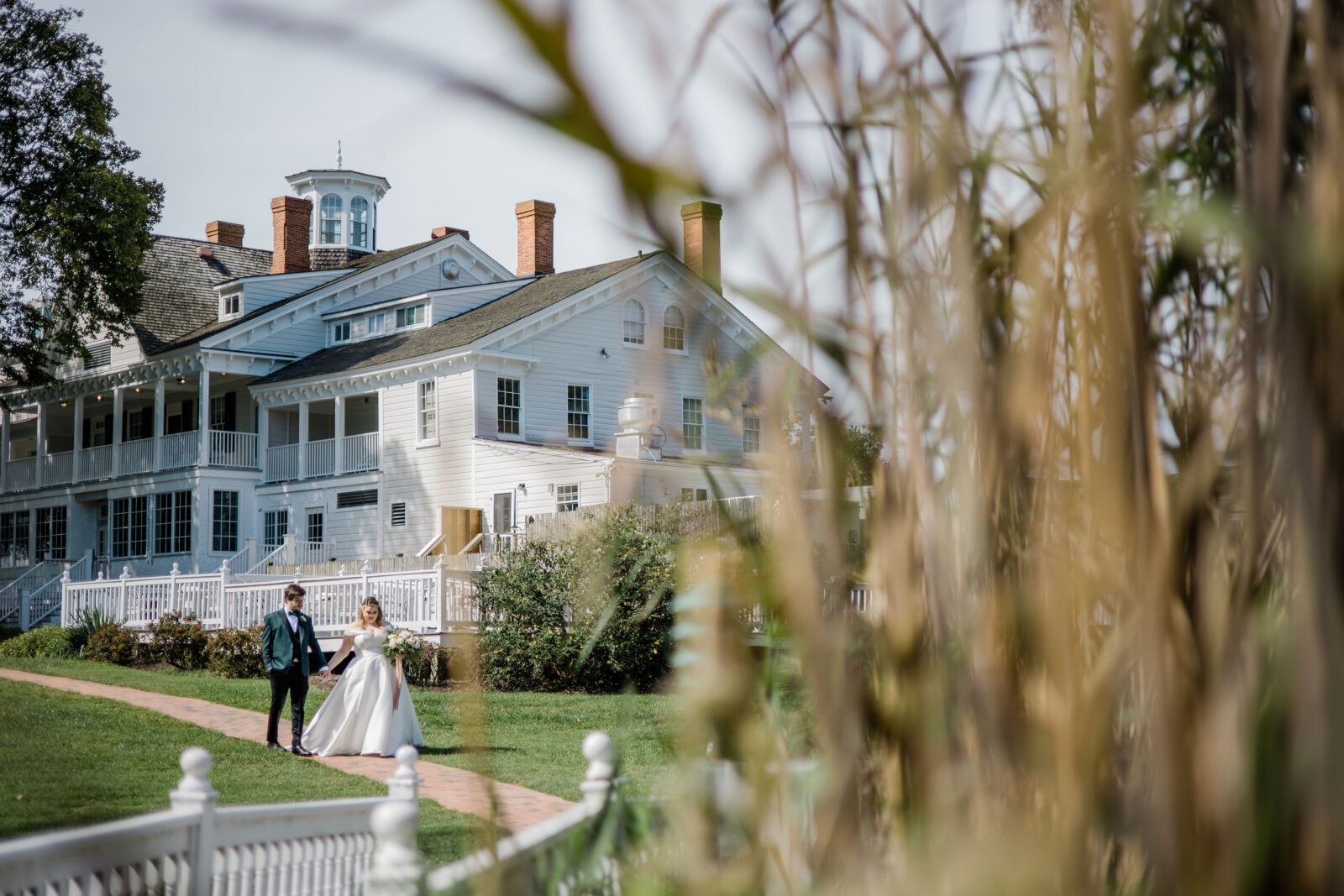 Bride and groom walking in front of Kent Island Resort wedding venue