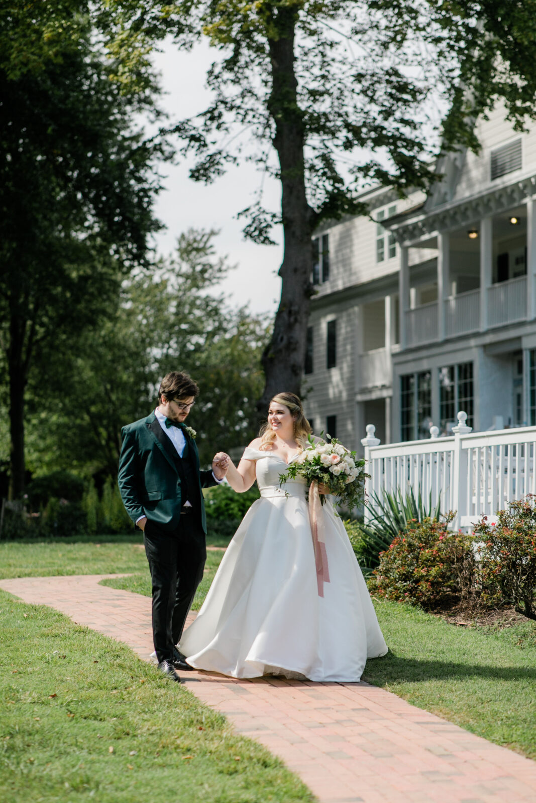 Bride and groom walking in front of Kent Island Resort wedding venue