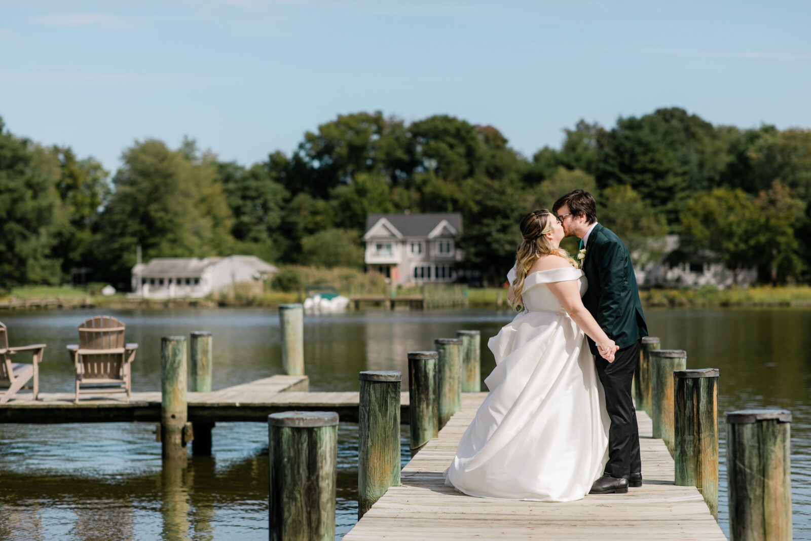 Bride and groom kissing on the dock at Kent Island resort