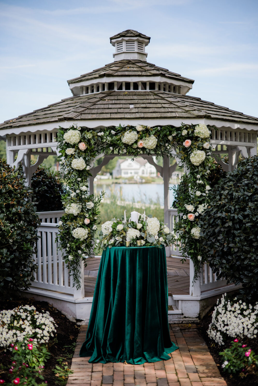 Gazebo decorated by florals and a unity candle