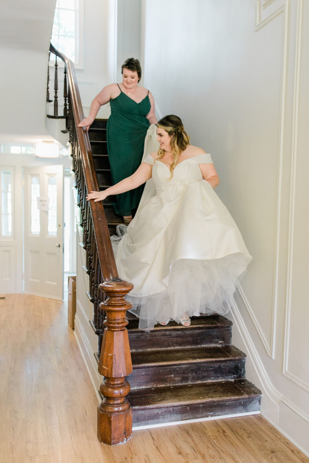 Bride and bridesmaid walking down stairs