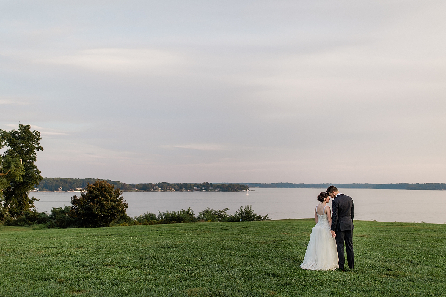 newlyweds look over the lake at Chesapeake Inn