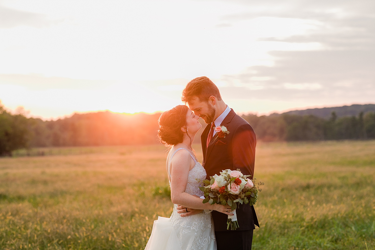 newlyweds share a hug in setting sun at Chesapeake Inn