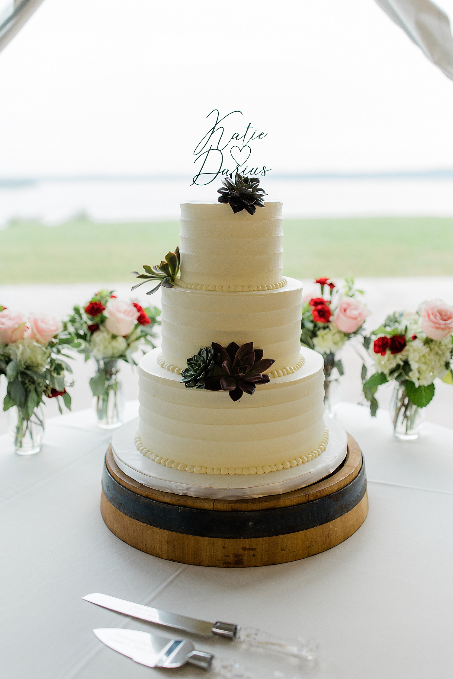 three tier white cake on table at reception at Chesapeake Inn