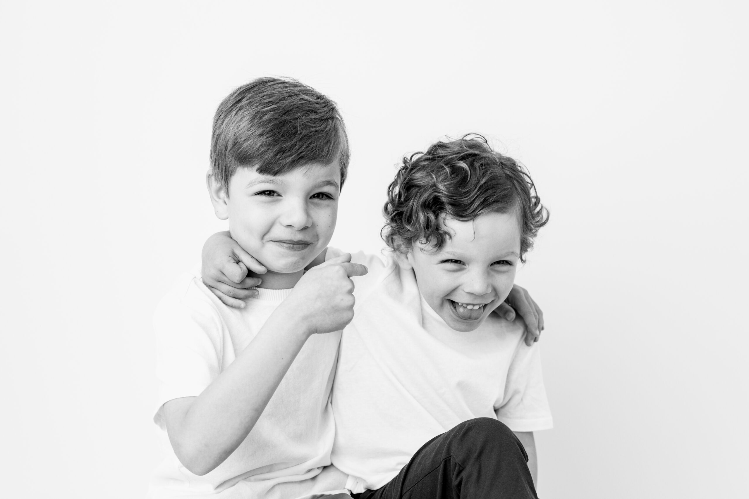 Baltimore children's photographer black and white portrait of two brothers laughing cheek to cheek