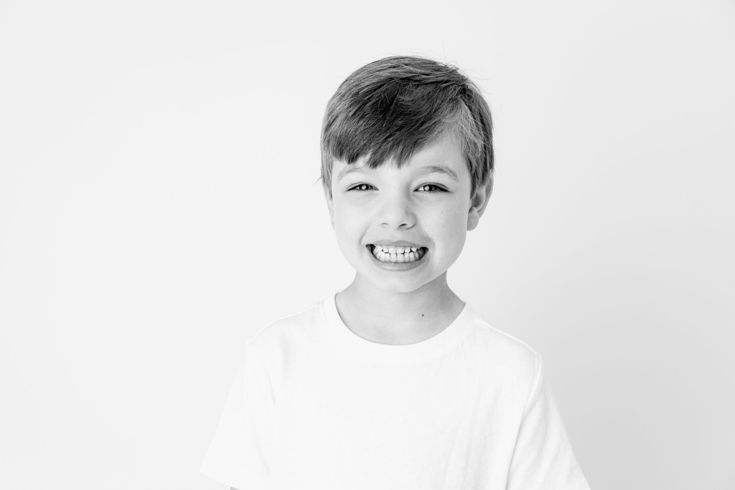 black and white image of a young boy smiling