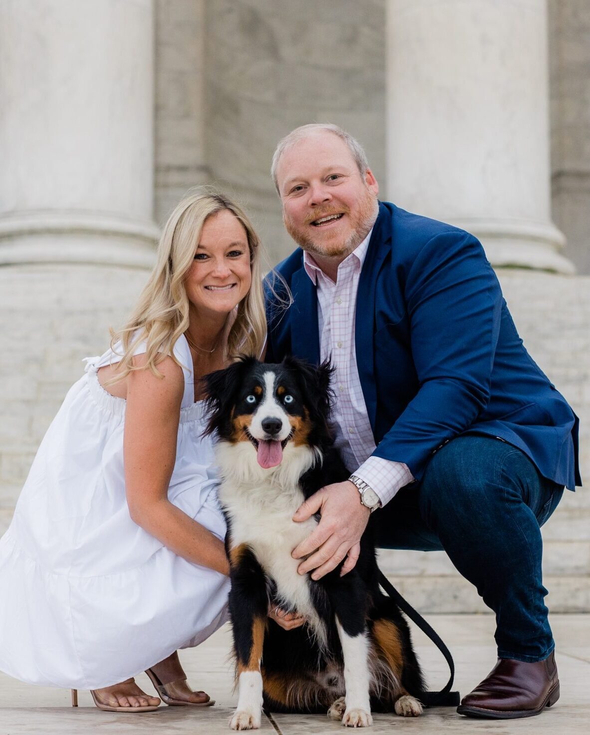 couple and their dog in front of the Jefferson memorial